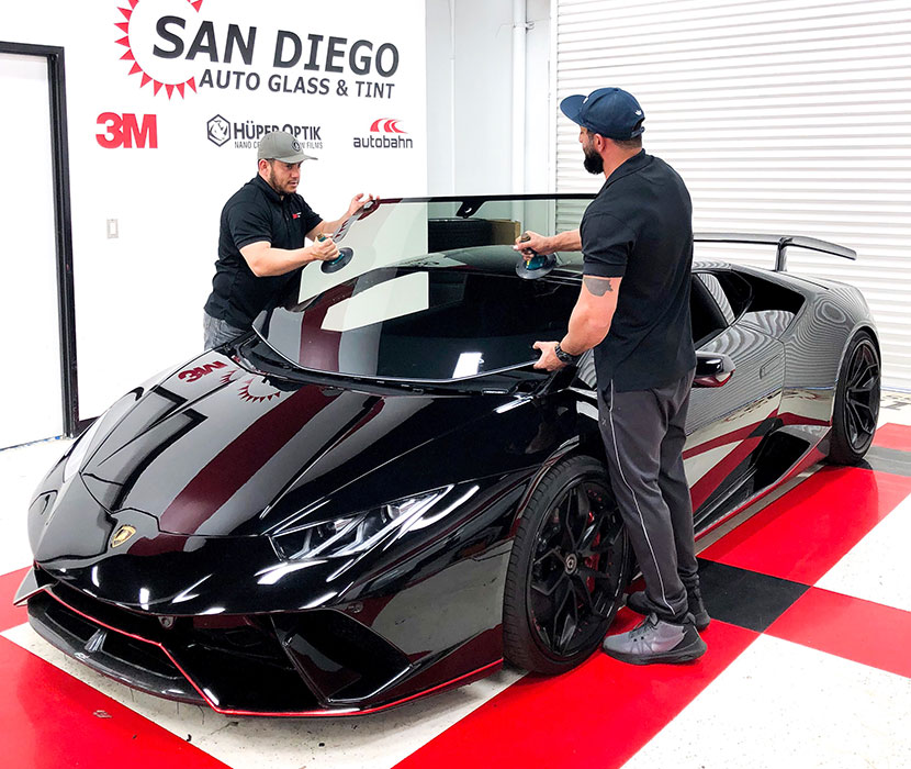 2 people installing auto glass at SD Auto Glass & Tint