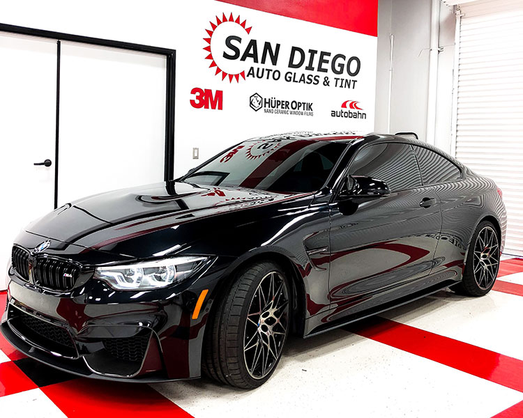 Black car parked inside of SD Auto Glass with Paint protection